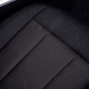 Close-up of a black car seat with visible texture
