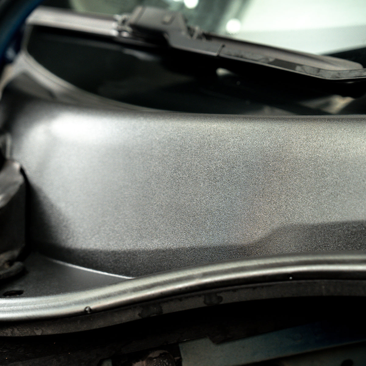 Close-up of a car's hood with a textured surface