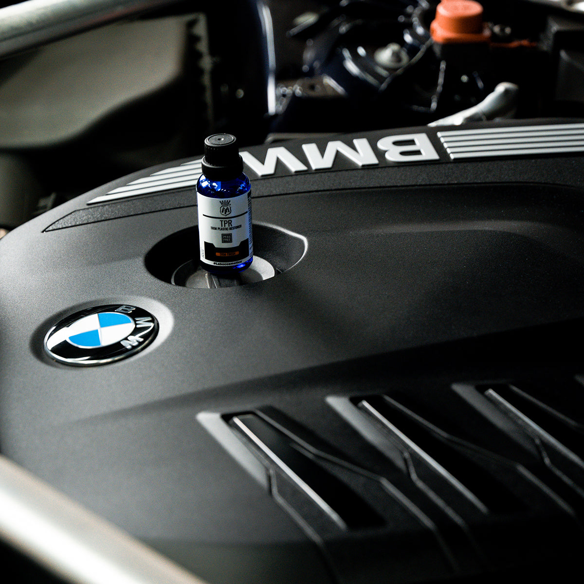 Bottle of Labocosmetica TPR on a BMW engine cover