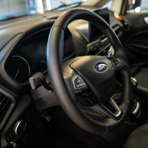 Steering wheel with Ford logo in a car interior