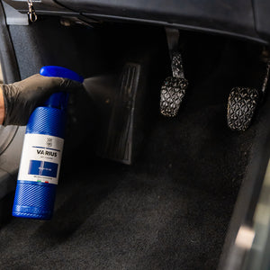 Person holding a Varius spray bottle inside a car.