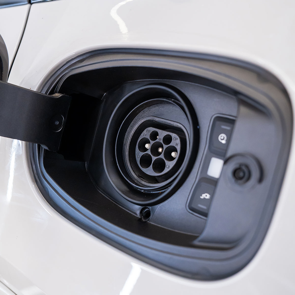 Close-up of an electric vehicle charging port.
