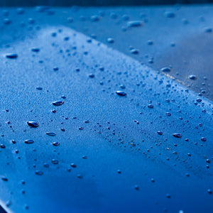 Close-up of water droplets on a blue surface