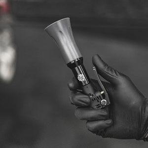 Hand holding a car air tool in a black and white setting