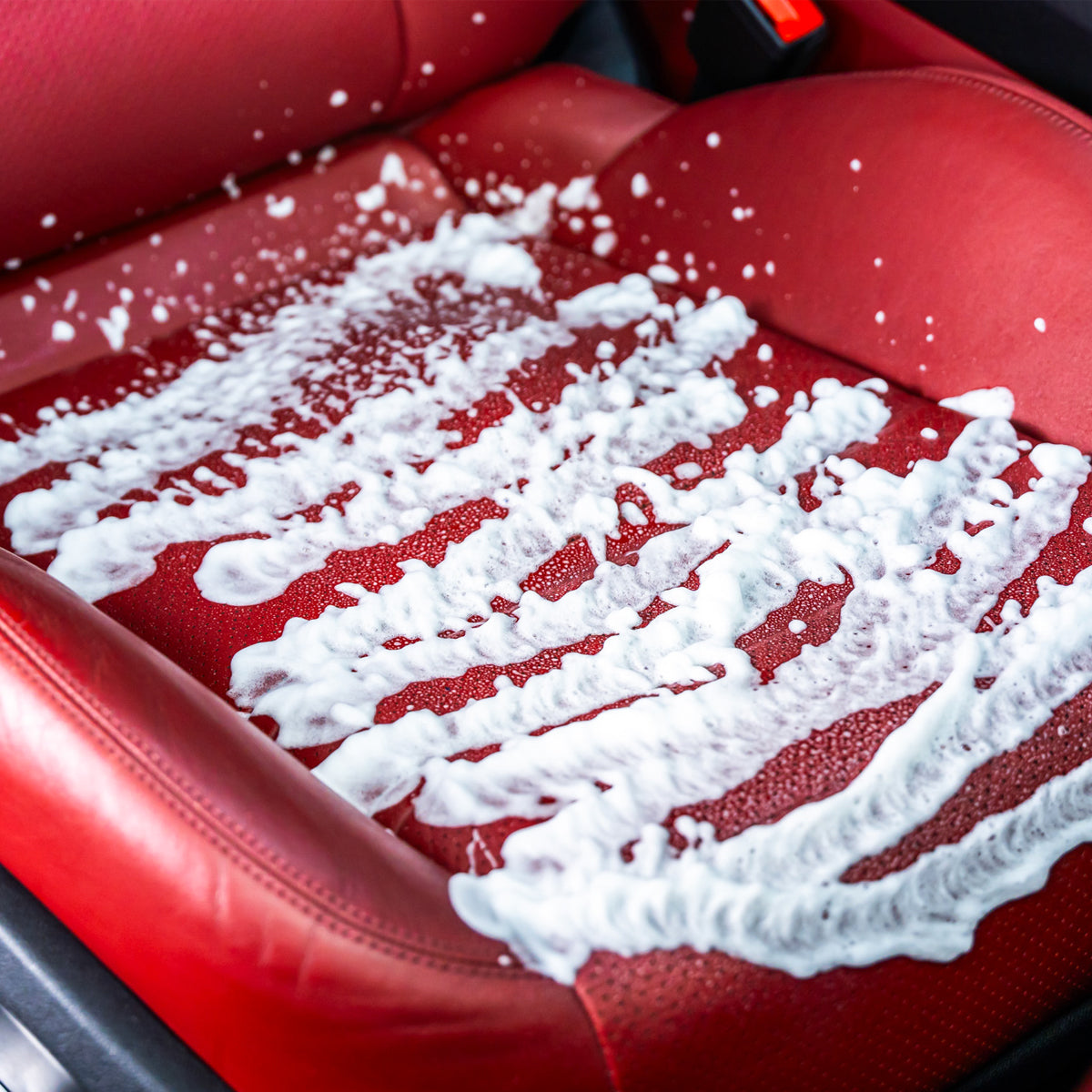 Red car seat with white cleaning foam