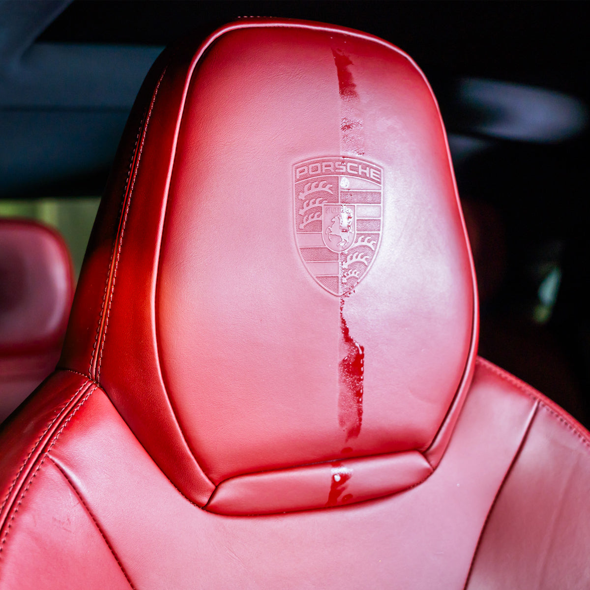 Red car seat with Porsche logo