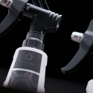 Close-up of a spray trigger with a brand logo on a black background