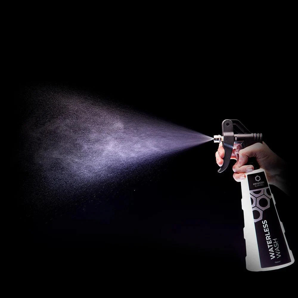 Spray gun with waterless wash solution on a black background